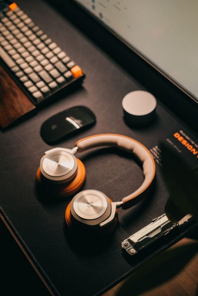 Stylish desk setup featuring headphones and tech accessories, perfect for a modern office.